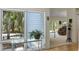 Bright interior view features a plant display in front of a large window looking out onto a wooded landscape at 2653 Seabrook Island Rd, Seabrook Island, SC 29455