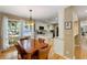 A view from the dining area into the kitchen with white cabinets, stainless steel appliances, and a window at 2653 Seabrook Island Rd, Seabrook Island, SC 29455