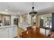 A well-lit kitchen and dining area with white cabinets and stainless steel appliances at 2653 Seabrook Island Rd, Seabrook Island, SC 29455