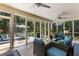 Enclosed patio featuring comfortable wicker furniture, ceiling fans and views of the lush surroundings at 2653 Seabrook Island Rd, Seabrook Island, SC 29455