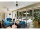 Enclosed patio featuring comfortable wicker furniture, ceiling fans and views of the lush surroundings at 2653 Seabrook Island Rd, Seabrook Island, SC 29455
