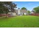 Expansive backyard showcasing a covered patio and a lush green lawn at 2845 August Rd, Johns Island, SC 29455