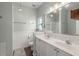 Well-lit bathroom featuring double sinks, wainscotting, and modern fixtures at 2845 August Rd, Johns Island, SC 29455