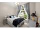 Cozy bedroom with a large window, neutral colors, and a decorative chandelier at 2845 August Rd, Johns Island, SC 29455