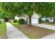 Charming home showcasing a driveway leading to a single-car garage and lush green landscaping at 2845 August Rd, Johns Island, SC 29455