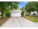 Traditional home with a spacious driveway, well-maintained lawn, and mature trees at 2845 August Rd, Johns Island, SC 29455