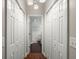 Hallway with wood flooring, closet space, and a view into the bathroom at 2845 August Rd, Johns Island, SC 29455