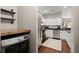 Well-lit kitchen featuring white cabinets, stainless steel appliances, and access to the laundry room at 2845 August Rd, Johns Island, SC 29455