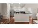 Well-lit kitchen with white cabinets, stainless steel appliances, and a view into the bedroom at 2845 August Rd, Johns Island, SC 29455