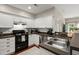 Bright kitchen features white cabinets, stainless steel appliances, and subway tile backsplash at 2845 August Rd, Johns Island, SC 29455