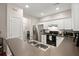 Bright kitchen features white cabinets, stainless steel appliances, and a view into the laundry room at 2845 August Rd, Johns Island, SC 29455