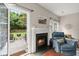 Cozy living room with a fireplace, patio access, and comfortable seating at 2845 August Rd, Johns Island, SC 29455