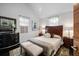 Comfortable bedroom with neutral tones, a decorative headboard, and window at 301 Broad St # 1, Charleston, SC 29401