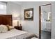 This bedroom showcases a luxurious bathroom through the door with elegant decor at 301 Broad St # 1, Charleston, SC 29401