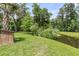 Lush backyard featuring mature trees, a tranquil pond, and serene natural surroundings at 348 Spindlewood Way, Charleston, SC 29414