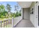 Balcony with white railing overlooks lush green trees and pond, offering serene outdoor living space at 348 Spindlewood Way, Charleston, SC 29414