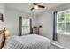 Bedroom featuring two windows, a ceiling fan, and a bed with matching end table at 348 Spindlewood Way, Charleston, SC 29414