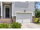 Charming home exterior boasting a two-car garage, gray siding, and brick accents at 348 Spindlewood Way, Charleston, SC 29414