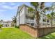 The townhome features a private balcony overlooking a well-maintained green space with lush palm trees at 348 Spindlewood Way, Charleston, SC 29414