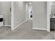 Bright hallway with neutral paint and plush carpeting leading to a bathroom and additional rooms at 348 Spindlewood Way, Charleston, SC 29414