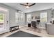 Well-lit home office with natural light, a ceiling fan, sleek desk, and minimalist decor at 348 Spindlewood Way, Charleston, SC 29414