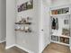 Bright mudroom boasts a built-in storage area with hooks, shelves, a seat, and decor on floating shelves at 348 Spindlewood Way, Charleston, SC 29414