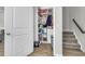 Walk-in pantry showcases abundant storage on the shelves, with access to the carpeted stairs at 348 Spindlewood Way, Charleston, SC 29414