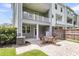 Back patio with outdoor seating and an upper balcony, perfect for relaxation and enjoying the outdoors at 348 Spindlewood Way, Charleston, SC 29414