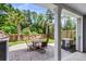 Outdoor patio area with brick pavers, a patio table and chairs, and a fenced yard with mature trees at 348 Spindlewood Way, Charleston, SC 29414