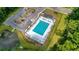 Aerial view of a pristine community pool, featuring a pool house, parking, and a scenic pond at 348 Spindlewood Way, Charleston, SC 29414