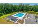 Inviting aerial view of a community pool featuring lounge chairs and a cabana surrounded by lush greenery at 348 Spindlewood Way, Charleston, SC 29414
