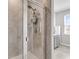 Modern bathroom with glass-enclosed shower, gray vanity with white countertop, and tile surround at 348 Spindlewood Way, Charleston, SC 29414