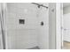 Modern tiled shower with a rainfall showerhead, built-in niche, and sleek design at 348 Spindlewood Way, Charleston, SC 29414