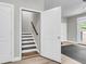 View of the modern wood staircase and the bright exercise room with outside access at 348 Spindlewood Way, Charleston, SC 29414