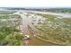 Picturesque aerial view of winding waterway with grassy marshes and a neighborhood on the shore at 3739 Goodwater St, Mount Pleasant, SC 29466