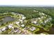 Aerial view of a neighborhood featuring a lake, lush greenery, and well-maintained landscaping at 3739 Goodwater St, Mount Pleasant, SC 29466