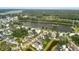 Aerial view showcasing a neighborhood with a lake, green spaces, and well-manicured lawns at 3739 Goodwater St, Mount Pleasant, SC 29466