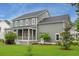 Spacious backyard with lush green lawn, a screened porch, and mature trees, perfect for outdoor activities at 3739 Goodwater St, Mount Pleasant, SC 29466