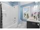 Bright bathroom featuring a shower with white tile, vanity with sink, and a large window at 3739 Goodwater St, Mount Pleasant, SC 29466