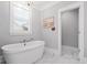 Bright bathroom featuring a freestanding tub, marble floors, and decorative artwork, providing a spa-like retreat at 3739 Goodwater St, Mount Pleasant, SC 29466