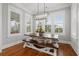 Breakfast area with natural light, modern light fixture, and a view of the lush, landscaped yard at 3739 Goodwater St, Mount Pleasant, SC 29466