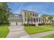 Charming two-story home boasts a welcoming front porch, manicured lawn, and a convenient three-car garage at 3739 Goodwater St, Mount Pleasant, SC 29466