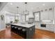 Open kitchen with island, barstool seating, modern pendant lighting and view to breakfast room at 3739 Goodwater St, Mount Pleasant, SC 29466