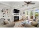 Well-lit living room showcases coffered ceilings, built-in shelves, a fireplace, and backyard access at 3739 Goodwater St, Mount Pleasant, SC 29466
