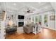 Bright living room featuring a fireplace, built-in shelving and access to an outdoor space at 3739 Goodwater St, Mount Pleasant, SC 29466