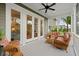 Relaxing screened porch furnished with wicker seating and a ceiling fan, perfect for enjoying the outdoors at 3739 Goodwater St, Mount Pleasant, SC 29466