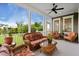 Inviting screened porch furnished with wicker seating and a ceiling fan, ideal for enjoying outdoor living at 3739 Goodwater St, Mount Pleasant, SC 29466