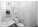 Charming powder room featuring a pedestal sink, toilet, and tasteful coastal-themed decor at 3739 Goodwater St, Mount Pleasant, SC 29466