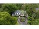 Aerial view of a beautiful two-story home with circular driveway surrounded by lush greenery and mature trees at 375 Seewee Cir, Mount Pleasant, SC 29464