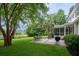Scenic backyard with a stone patio, grill, lush lawn, and serene view of the waterway at 375 Seewee Cir, Mount Pleasant, SC 29464
